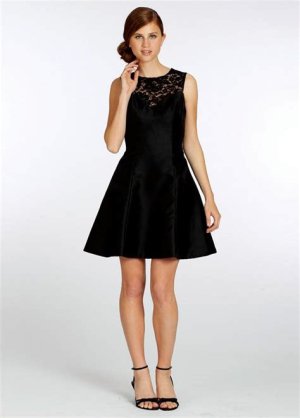 A romantic black lace fit-and-flare dress with long sleeves and intricate lace detailing, paired with metallic heels and subtle jewelry.