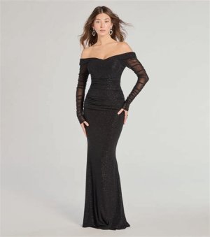 A stunning black off-the-shoulder mermaid gown featuring a fitted bodice and flared skirt, styled with drop earrings and a sleek clutch.