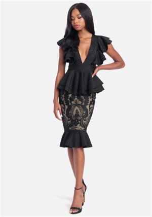 Black peplum dress with ruffle details, creating a stylish and flattering silhouette for a chic winter wedding outfit.