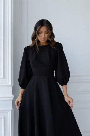 Elegant black midi dress with puff sleeves, offering a timeless and sophisticated look for winter weddings.